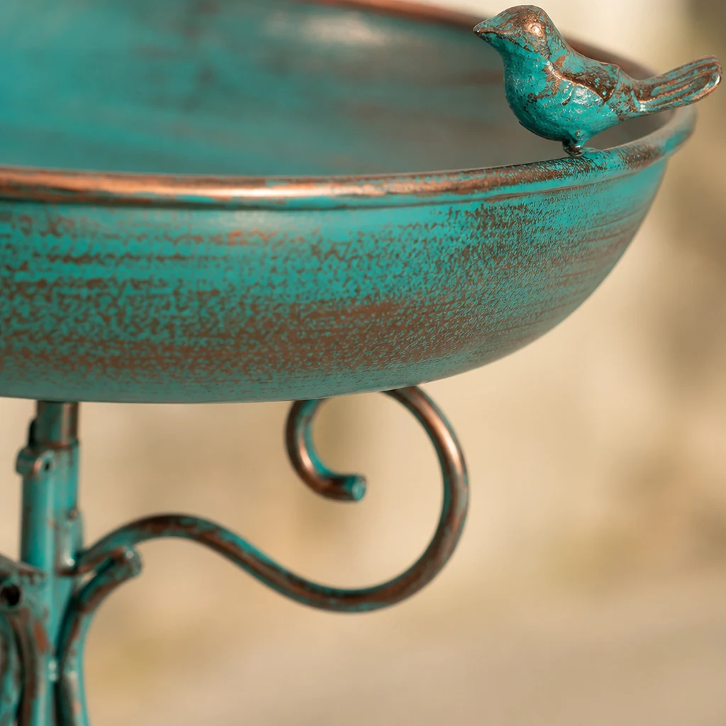 Green-bronze basin rim and bird ornament in close detail