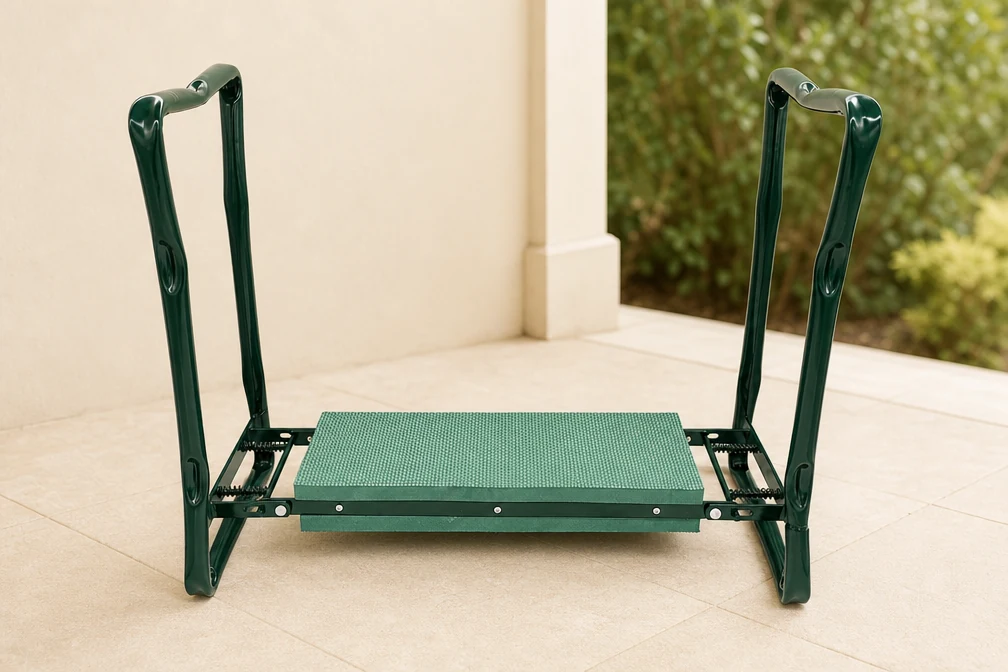 Green folding kneeler standing open on a terrace