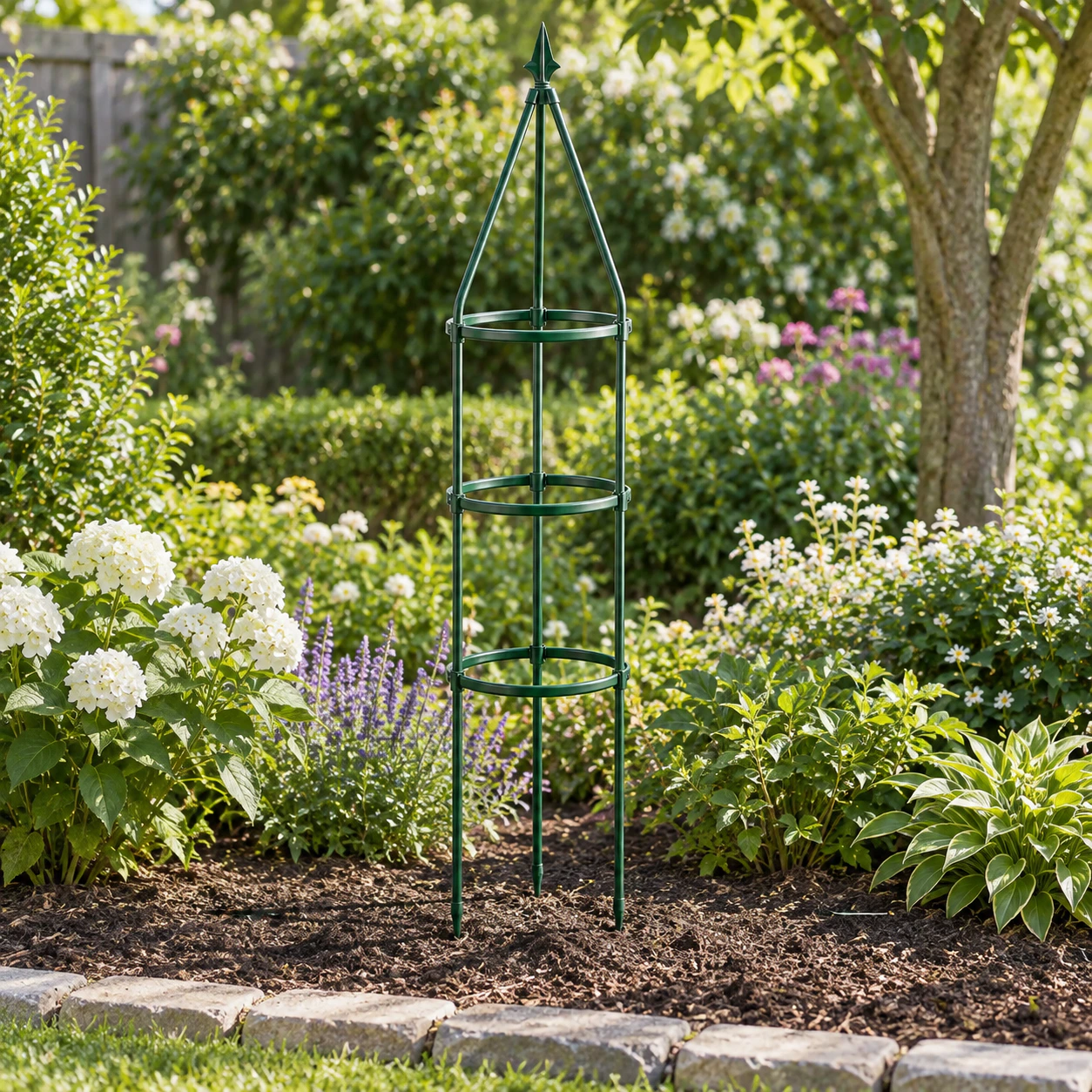 Green three-ring spear trellis installed in a planted garden border